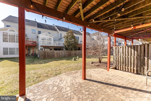 view of patio featuring fence and a residential view