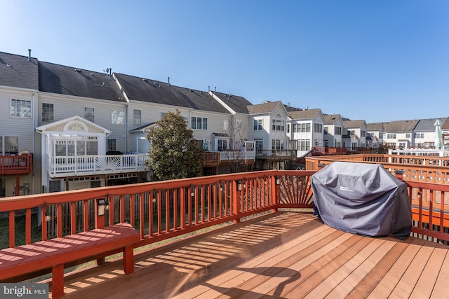 wooden terrace featuring a residential view and grilling area