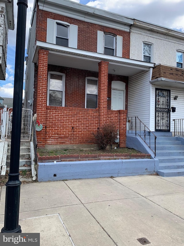 townhome / multi-family property featuring brick siding