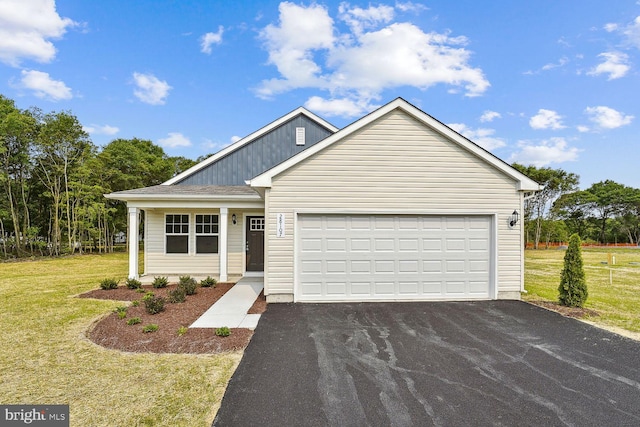 view of front of house featuring a garage, a front yard, and driveway