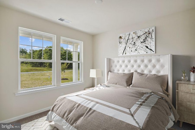 bedroom with carpet, visible vents, and baseboards