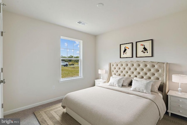 carpeted bedroom featuring visible vents and baseboards