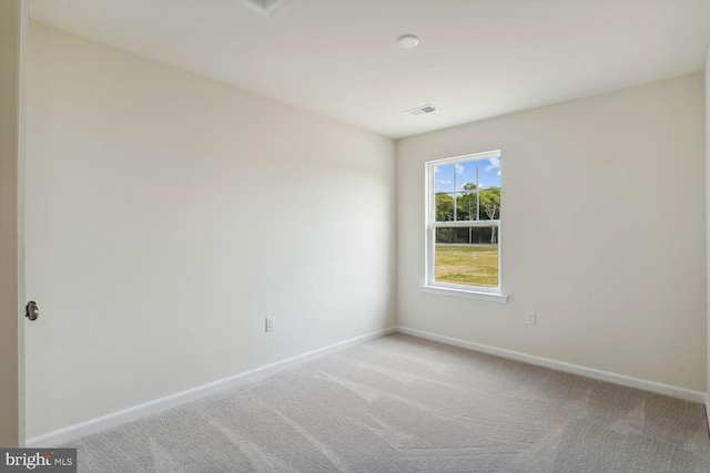 unfurnished room featuring carpet floors, baseboards, and visible vents