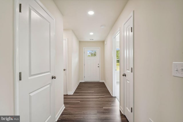 doorway with dark wood-style flooring, recessed lighting, and baseboards