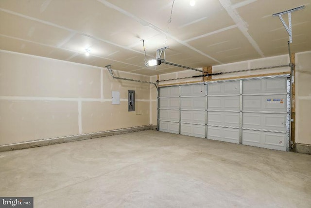 garage with a garage door opener and electric panel