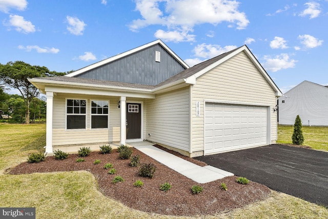 ranch-style house featuring a front yard, driveway, and an attached garage