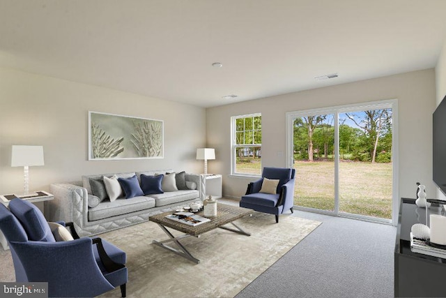 living room featuring visible vents and carpet flooring