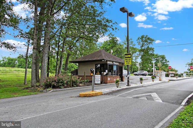 view of street featuring curbs, street lighting, and traffic signs