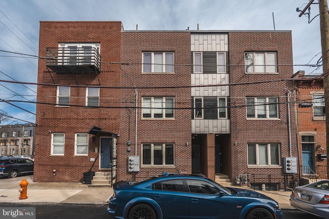 view of front of home featuring entry steps and brick siding