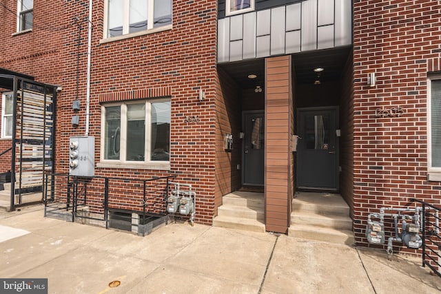 property entrance with brick siding