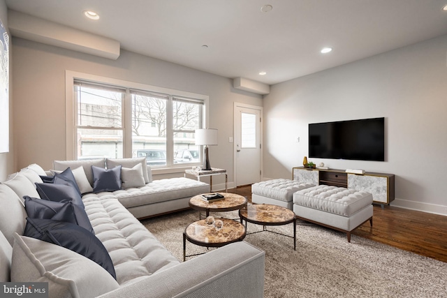 living room with baseboards, wood finished floors, and recessed lighting