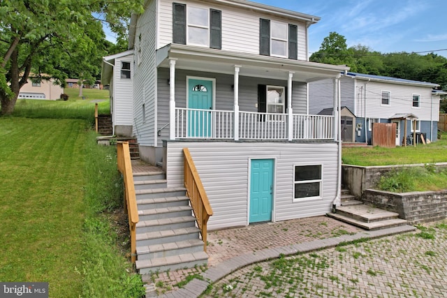 view of front of house with covered porch, stairway, and a front yard