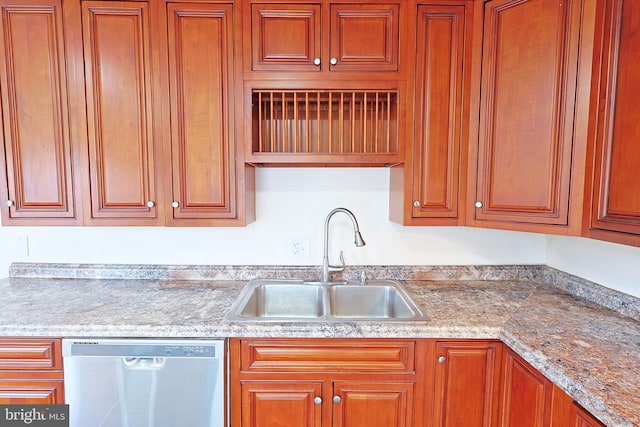 kitchen featuring a sink, brown cabinets, and dishwasher