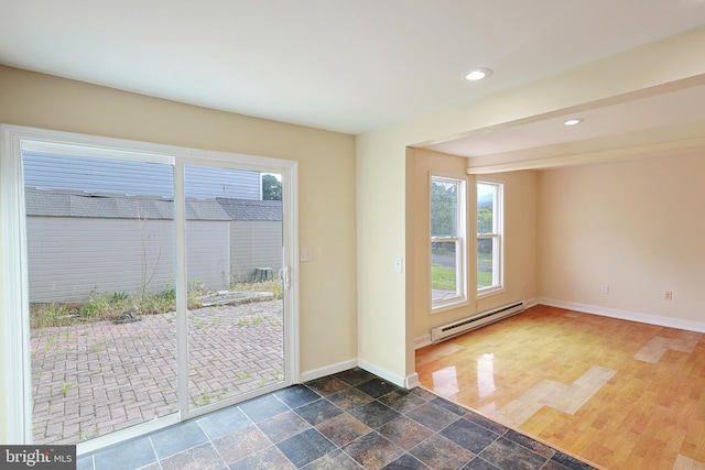 doorway to outside with baseboards, baseboard heating, stone tile flooring, and recessed lighting