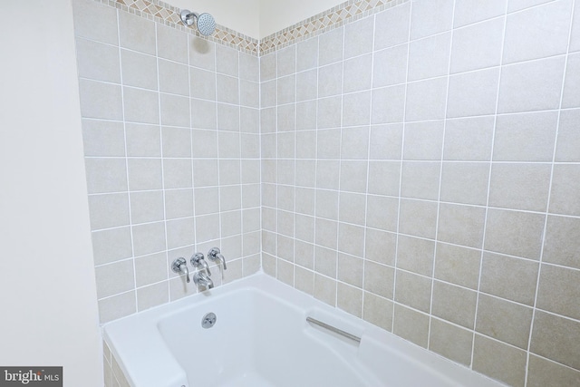 bathroom featuring a washtub and walk in shower