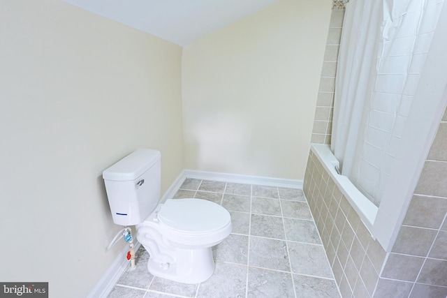 full bath with tile patterned flooring, baseboards, and toilet