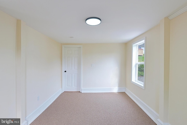 unfurnished room featuring baseboards and carpet flooring