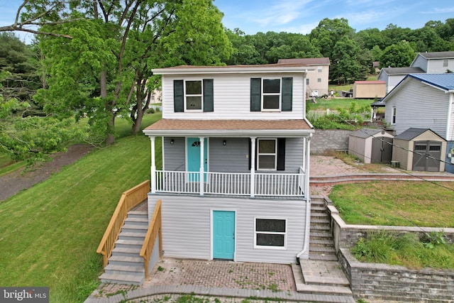 view of front of property with a storage shed, stairs, an outdoor structure, a front lawn, and a porch