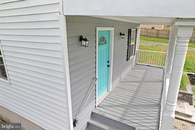 view of exterior entry featuring fence