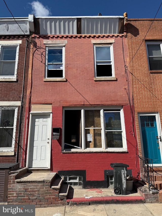 view of property featuring brick siding