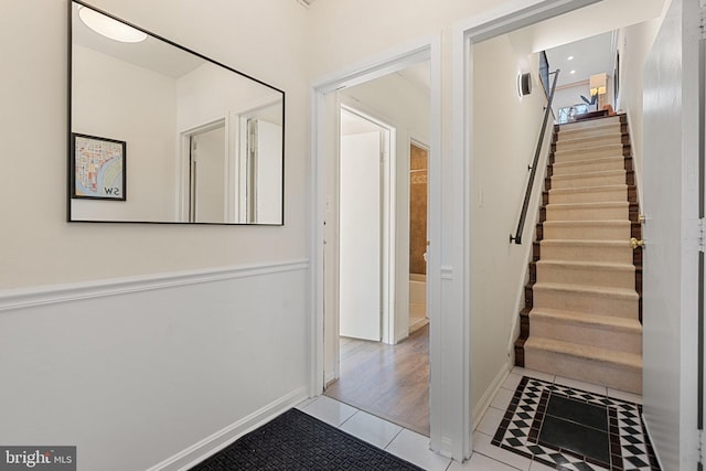 interior space featuring baseboards, stairway, and tile patterned floors