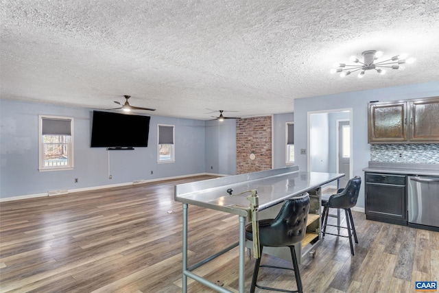 kitchen featuring dishwasher, plenty of natural light, and wood finished floors