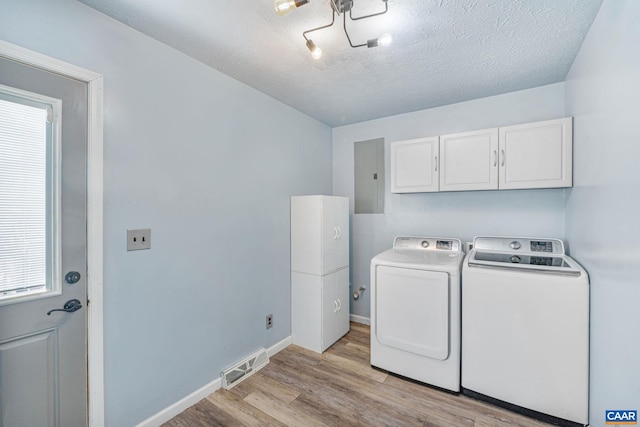 laundry area featuring visible vents, baseboards, independent washer and dryer, cabinet space, and light wood finished floors