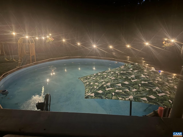 pool at twilight with an indoor pool