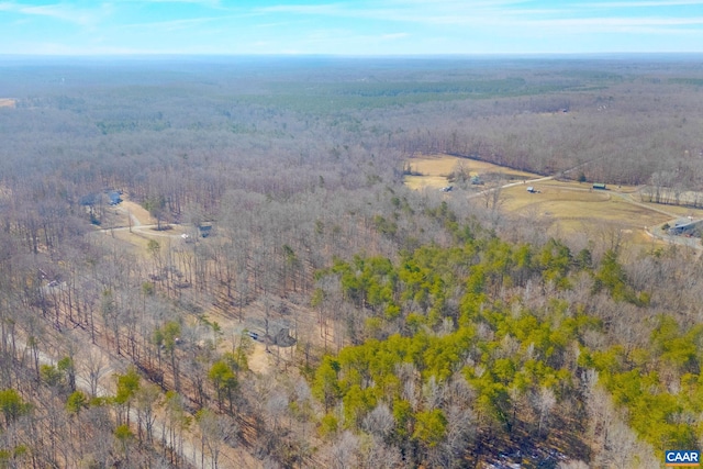 birds eye view of property featuring a wooded view