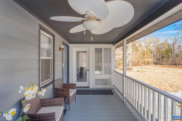 wooden deck featuring ceiling fan