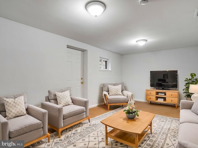 living area with light wood-style floors and baseboards