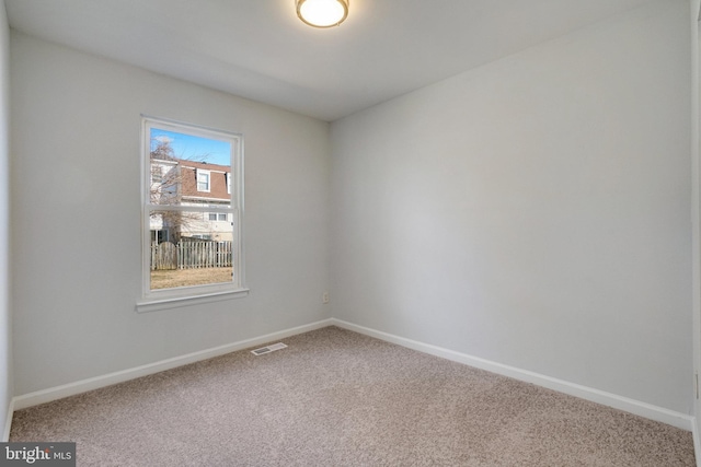 carpeted empty room with baseboards and visible vents