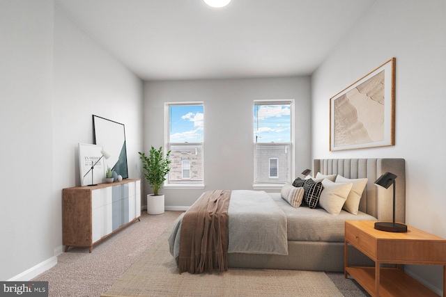 bedroom featuring carpet and baseboards