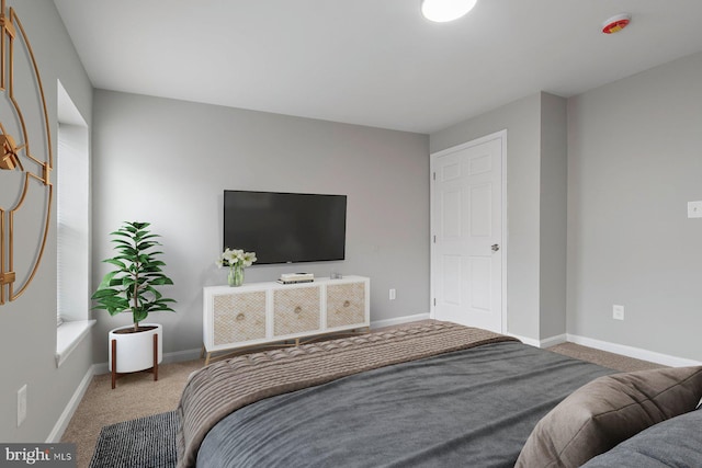 bedroom featuring carpet floors and baseboards