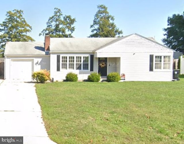 ranch-style house featuring a front lawn, concrete driveway, a chimney, and an attached garage