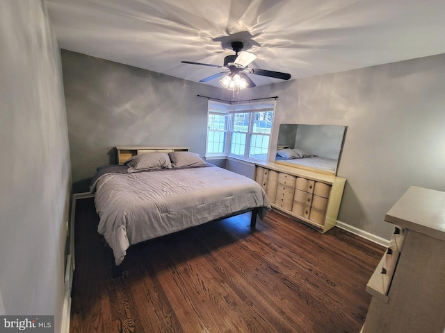 bedroom featuring a ceiling fan, dark wood finished floors, and baseboards