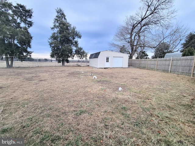 view of yard with an outbuilding and a fenced backyard