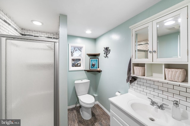 full bathroom with visible vents, backsplash, toilet, a stall shower, and wood finished floors