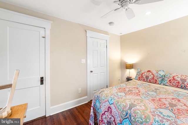 bedroom with ceiling fan, wood finished floors, and baseboards