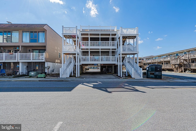 view of property featuring stairway and central air condition unit