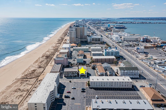 bird's eye view featuring a water view and a view of the beach