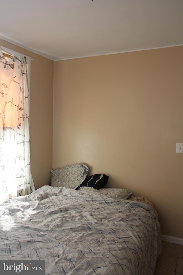 tiled bedroom with baseboards