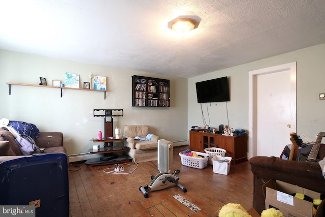 living area featuring a textured ceiling and hardwood / wood-style floors