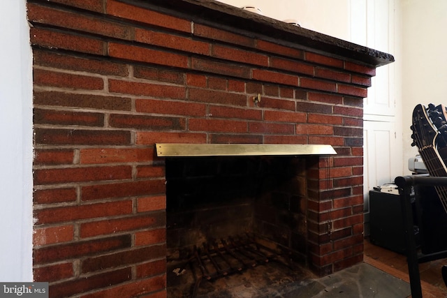 interior details with a brick fireplace