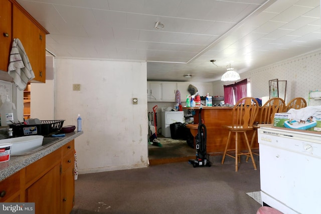 interior space featuring carpet floors, washer / clothes dryer, and wallpapered walls