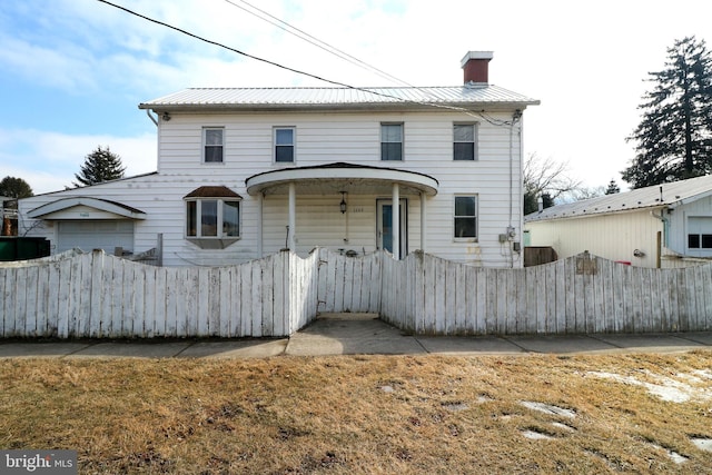 view of front of property with metal roof, fence, and a chimney