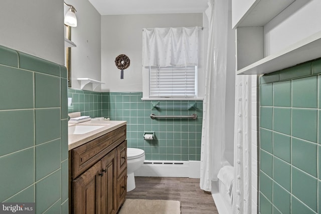 full bath with tile walls, toilet, wainscoting, vanity, and wood finished floors