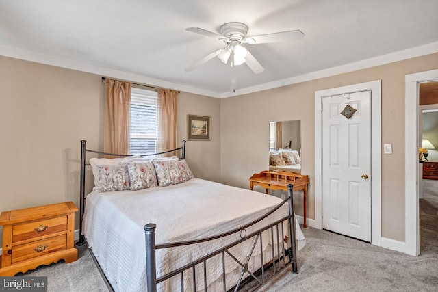 bedroom with a ceiling fan, light carpet, and baseboards