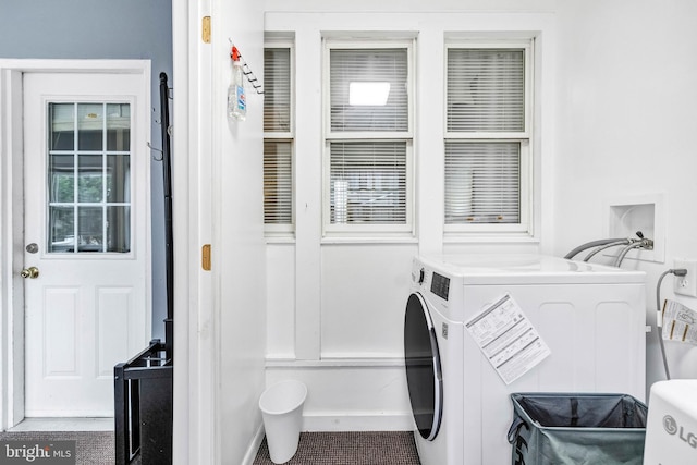 clothes washing area featuring separate washer and dryer