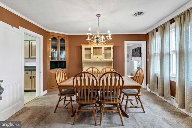 dining area featuring light carpet, visible vents, a chandelier, and ornamental molding